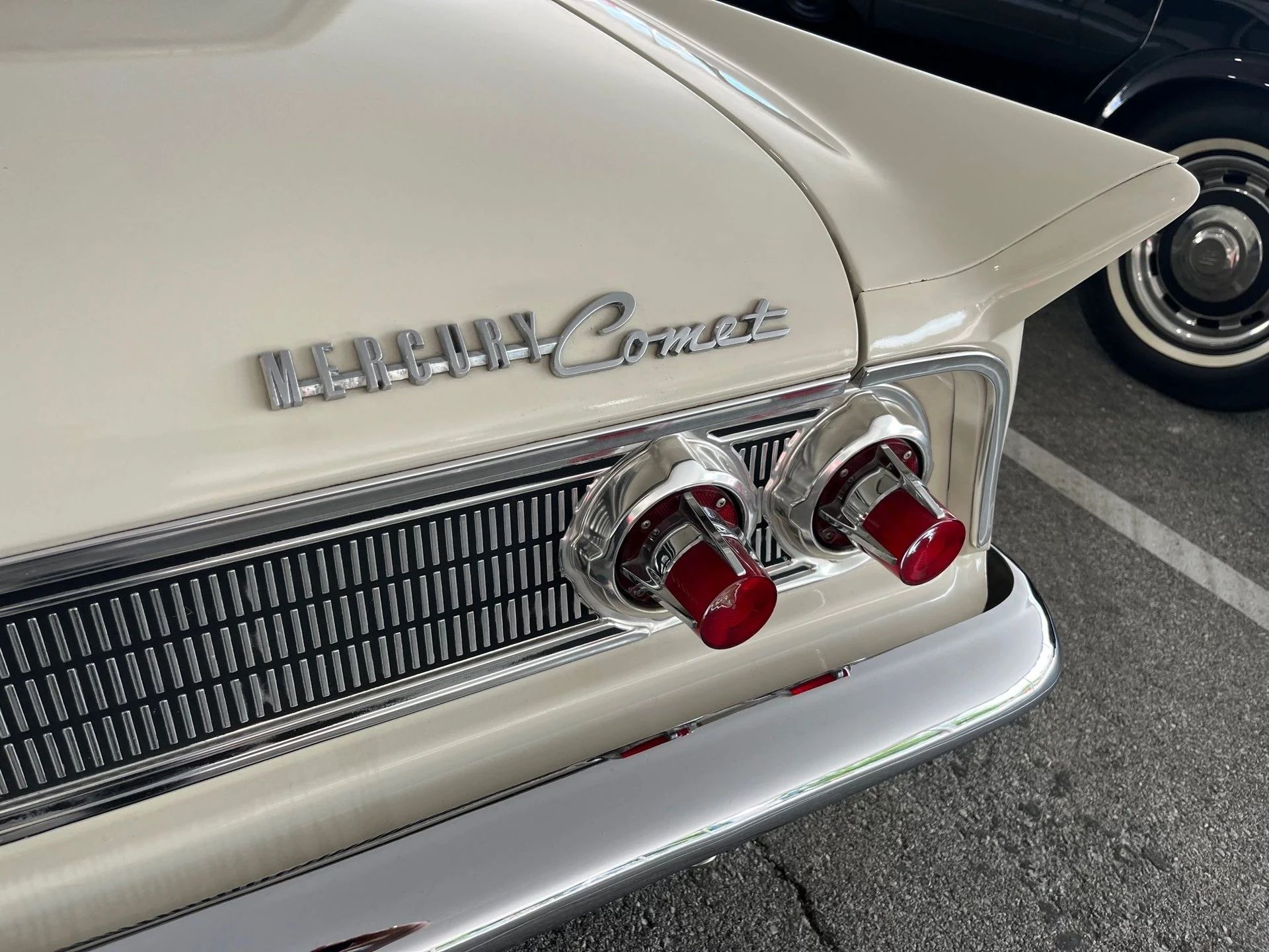 1963 Mercury Comet V-8 Sedan: "For Better Or For Worse, Something Different Under The Hood" 20 Right taillights, tail fin, and Mercury Comet badge on a white car