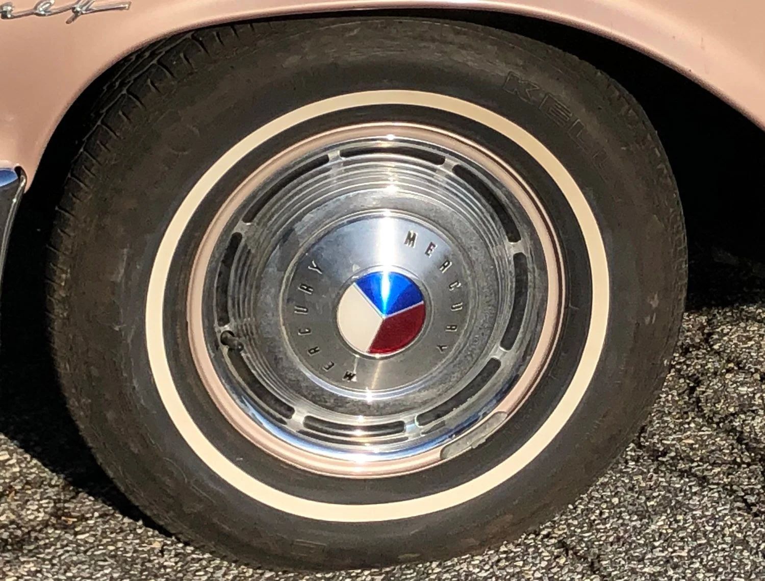 1963 Mercury Monterey S-55 Two-Door Hardtop: One-Year-Only Bucket-Seat Breezeway 18 Whitewall and wheel cover on a pink 1963 Mercury