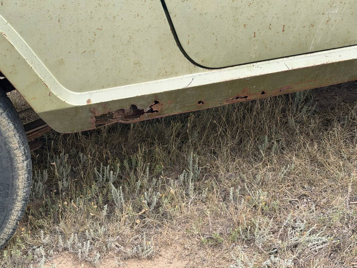 Rocker panel rust on green 1970 Jeepster Commando