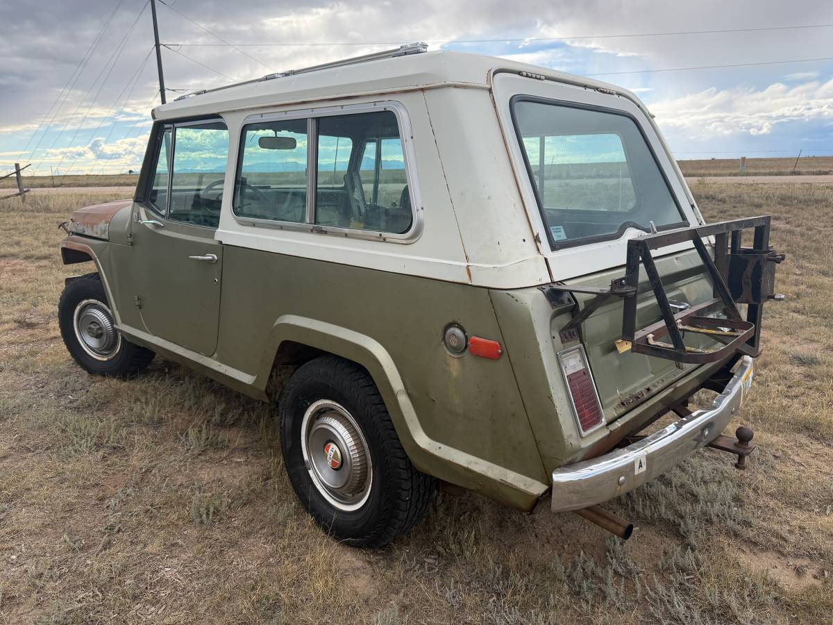 Driver rear 3q picture of green 1970 Jeepster Commando with white hardtop