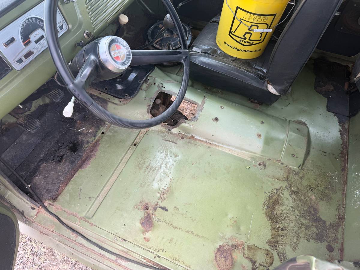 Driver floorpan of green 1970 Jeepster Commando
