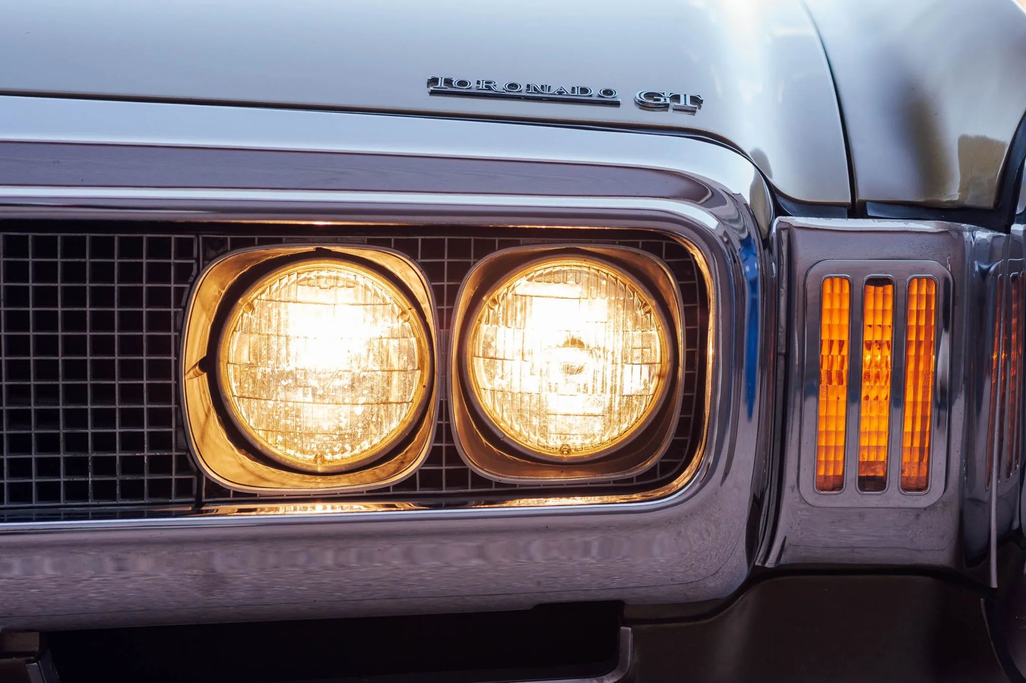 1970 Oldsmobile Toronado GT: 400 Horsepower And A Face Only A Mother Could Love 32 Illuminated left front headlights of a 1970 Toronado, with Toronado GT badge visible above them