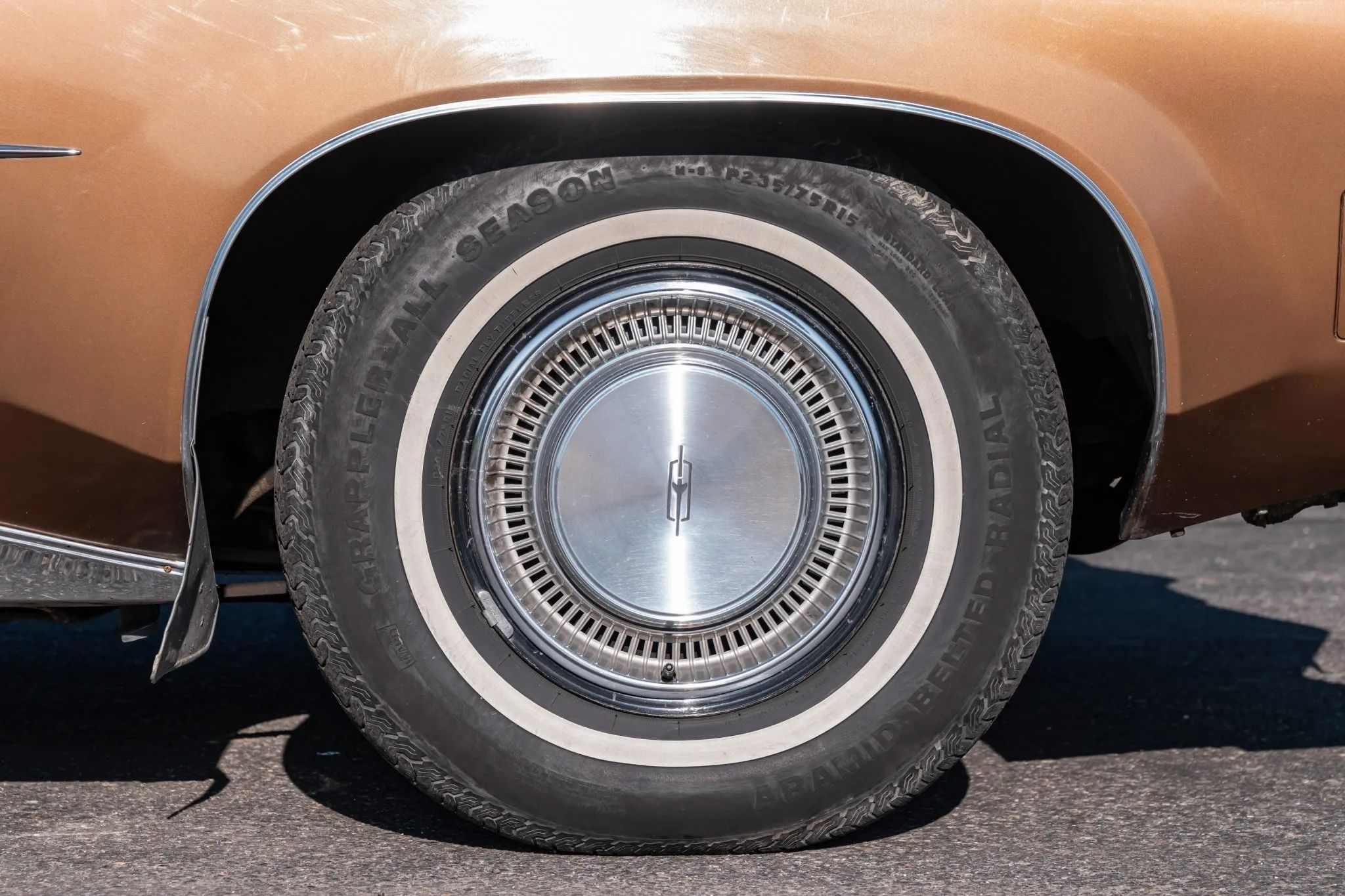 1972 Oldsmobile Ninety-Eight Luxury Sedan: A Full-Size Luxury Bargain From Big Sky Country 14 Whitewall tire and wheel cover on the left front wheel of a 1972 Oldsmobile
