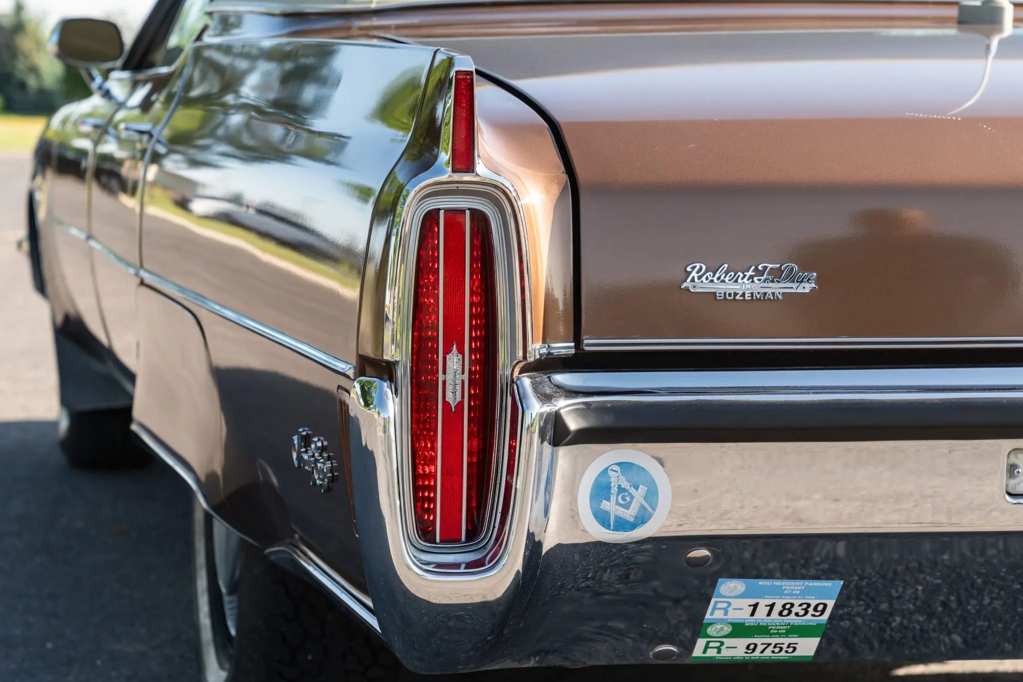 1972 Oldsmobile Ninety-Eight Luxury Sedan: A Full-Size Luxury Bargain From Big Sky Country 11 Left rear taillight of a 1972 Oldsmobile with a Robert F. Dye dealer badge on the decklid