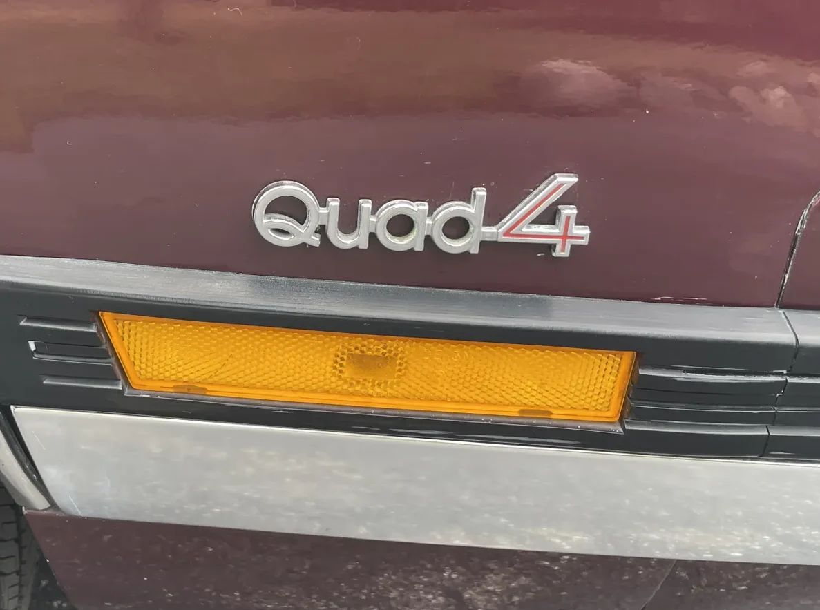 1988 Oldsmobile Cutlass Calais With Quad 4 And Rare 5-Speed: "A Heady Blend of High Revs and Haut Velour" 2 Quad 4 badge on the right front fender of a 1988 Oldsmobile
