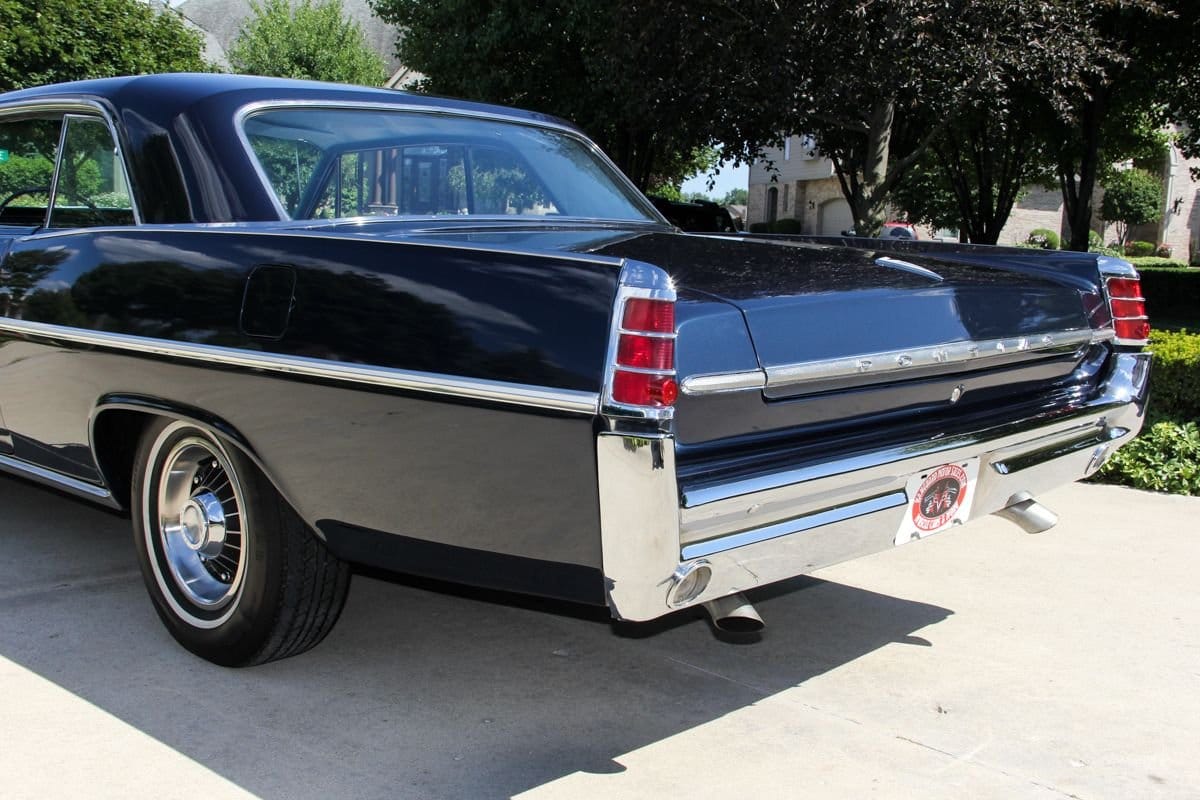 1964 Pontiac Catalina Ventura: When Choosing A Favorite Big Pontiac, Why Not A '64? 6 Rear end of a dark blue 1963 Pontiac Catalina as seen from the driver side parked in a driveway