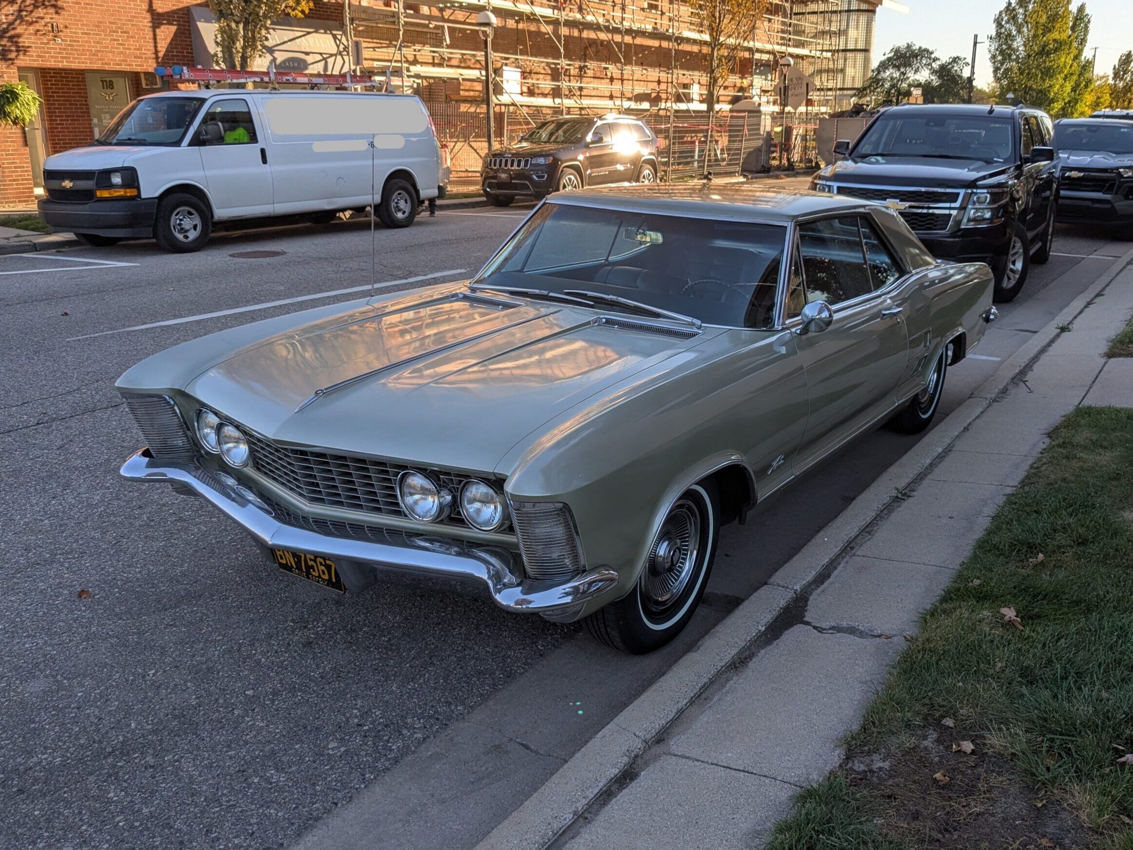 Riviera, Thunderbird, Eldorado, Toronado, Or GT Hawk: Which 1960s Personal Luxury Coupe Is *Your* Favorite? 2 High driver front 3q picture of tan 1963 Buick Riviera parallel parked on a city street