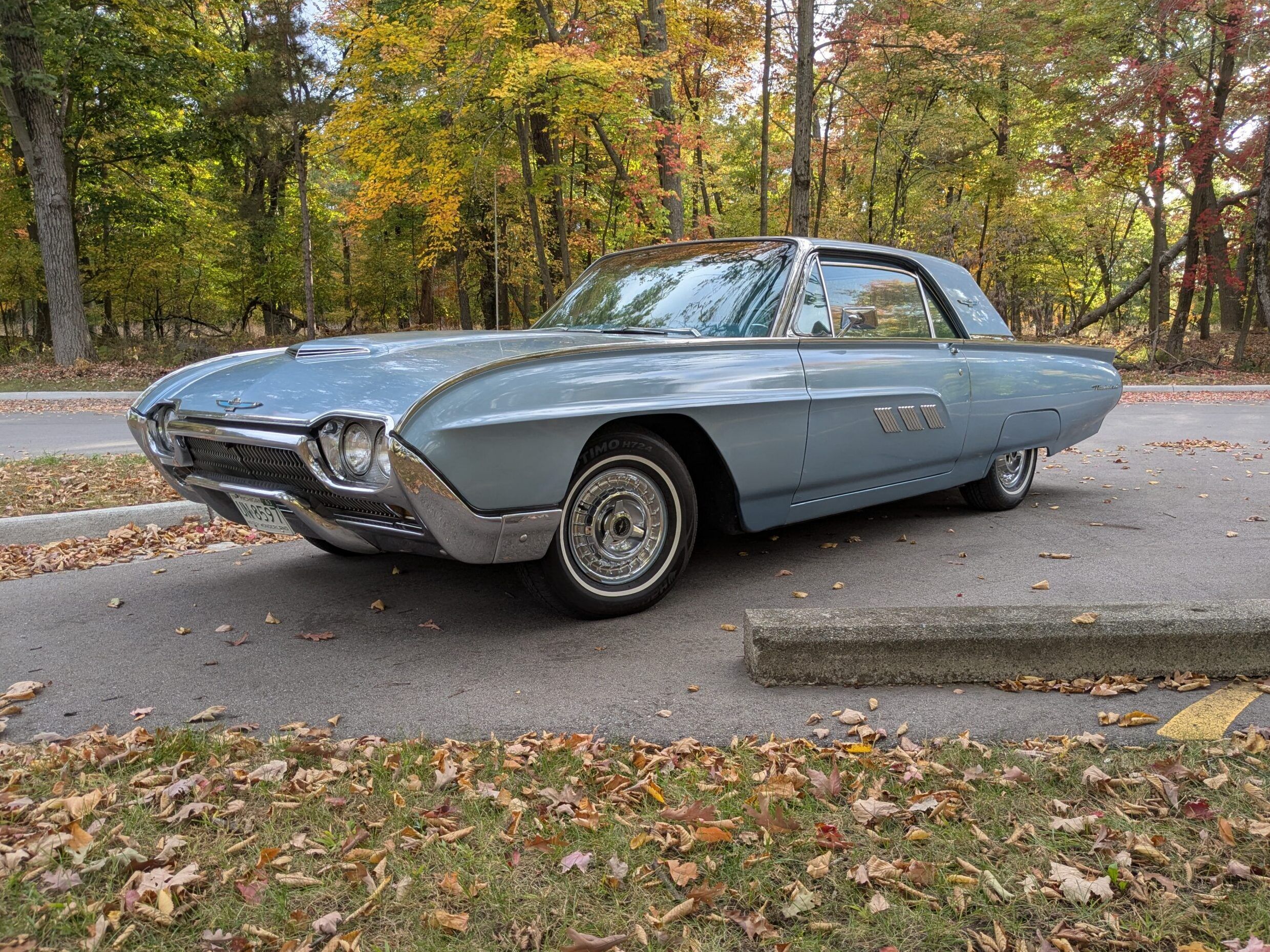 Riviera, Thunderbird, Eldorado, Toronado, Or GT Hawk: Which 1960s Personal Luxury Coupe Is *Your* Favorite? 6 Driver front 3q picture of blue 1963 Ford Thunderbird parked in an autumnal wooded area