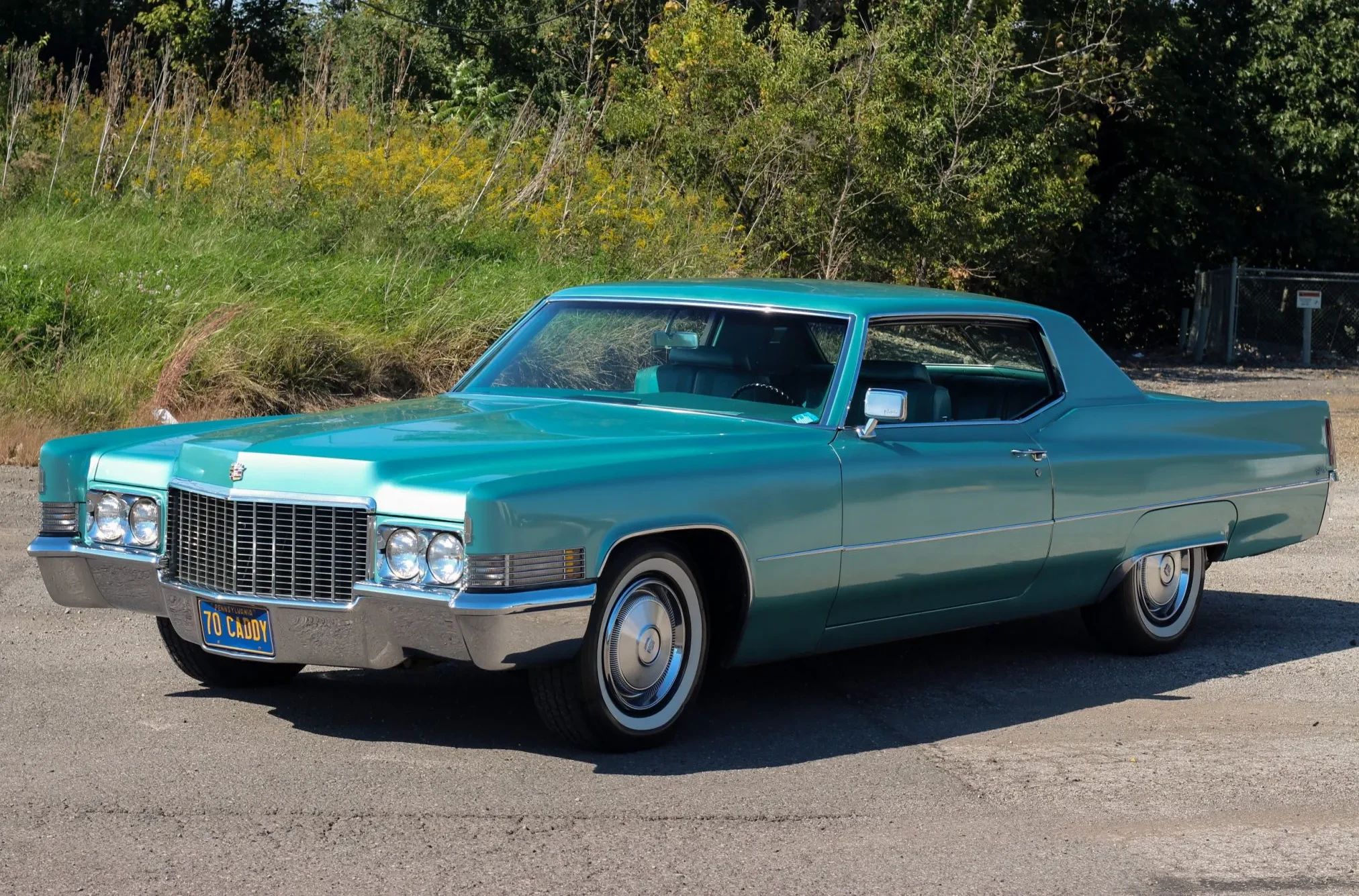 Driver front 3q picture of turquoise 1970 Cadillac Calais Coupe parked in a lot