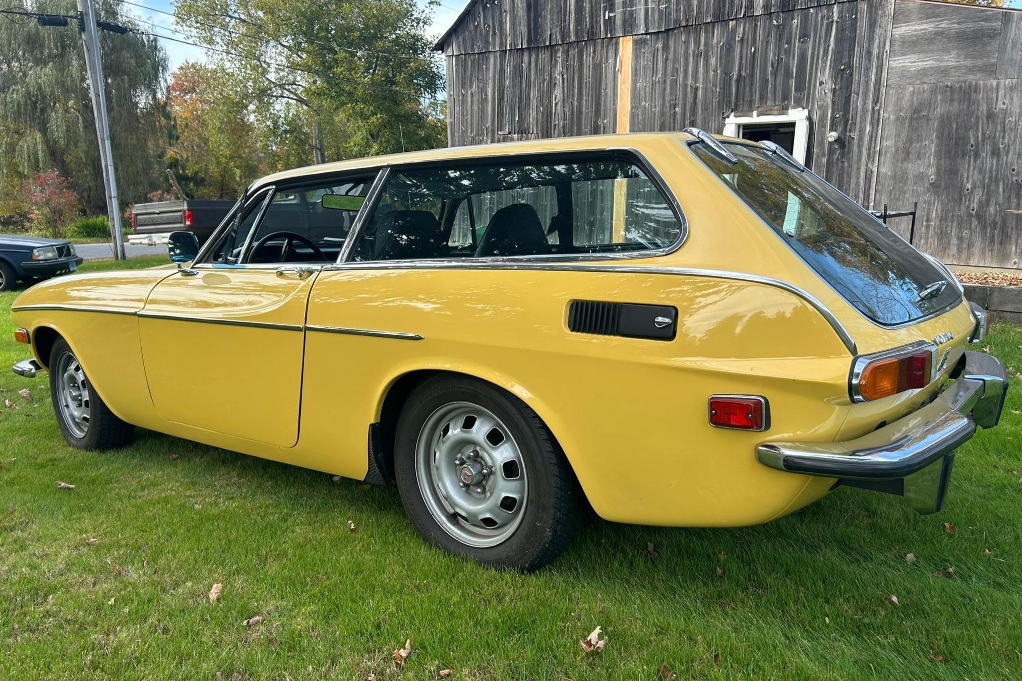 Driver rear 3q picture of yellow 1972 Volvo 1800ES