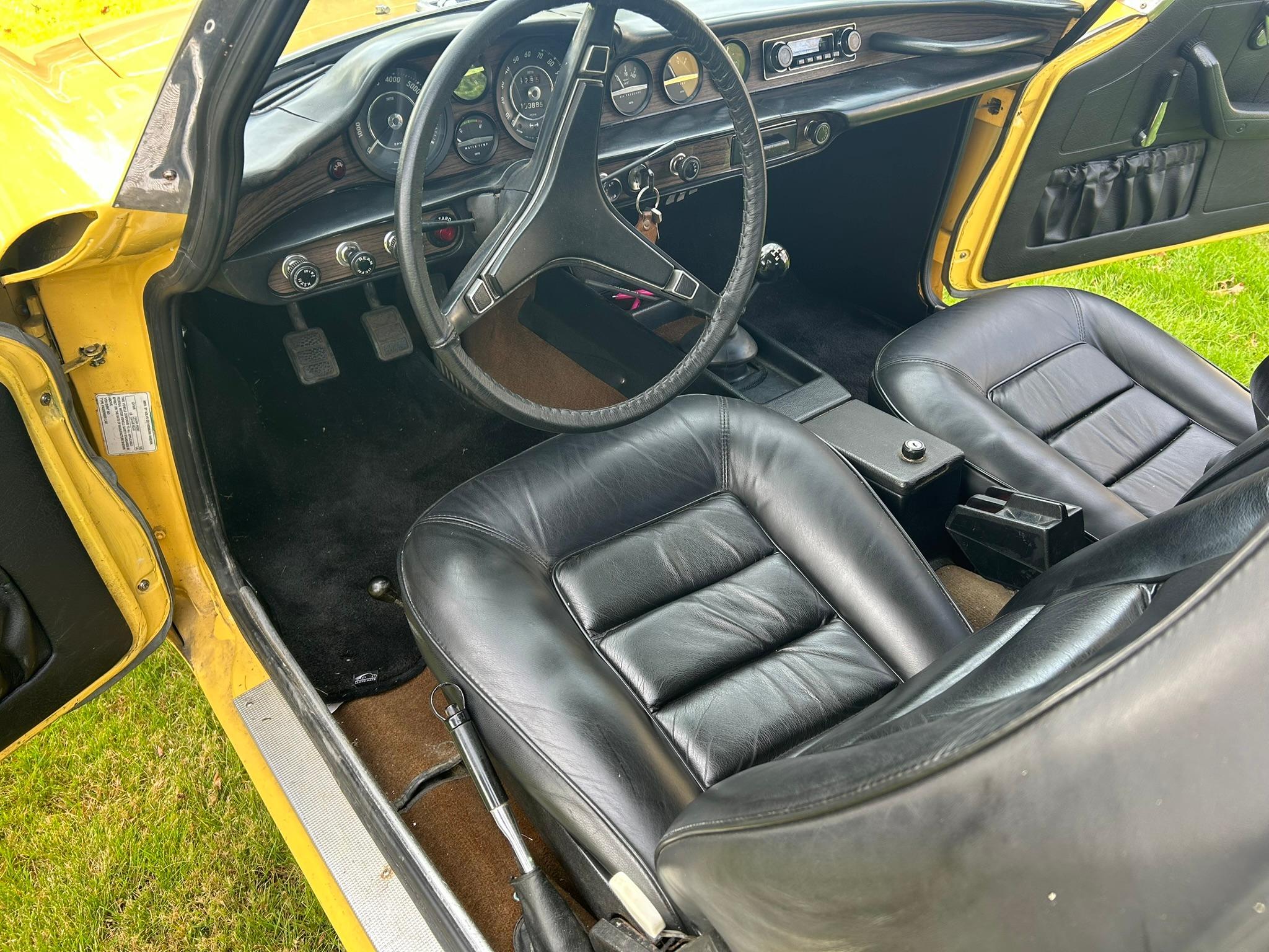 Interior of 1972 Volvo 1800ES with black bucket seats and accessories