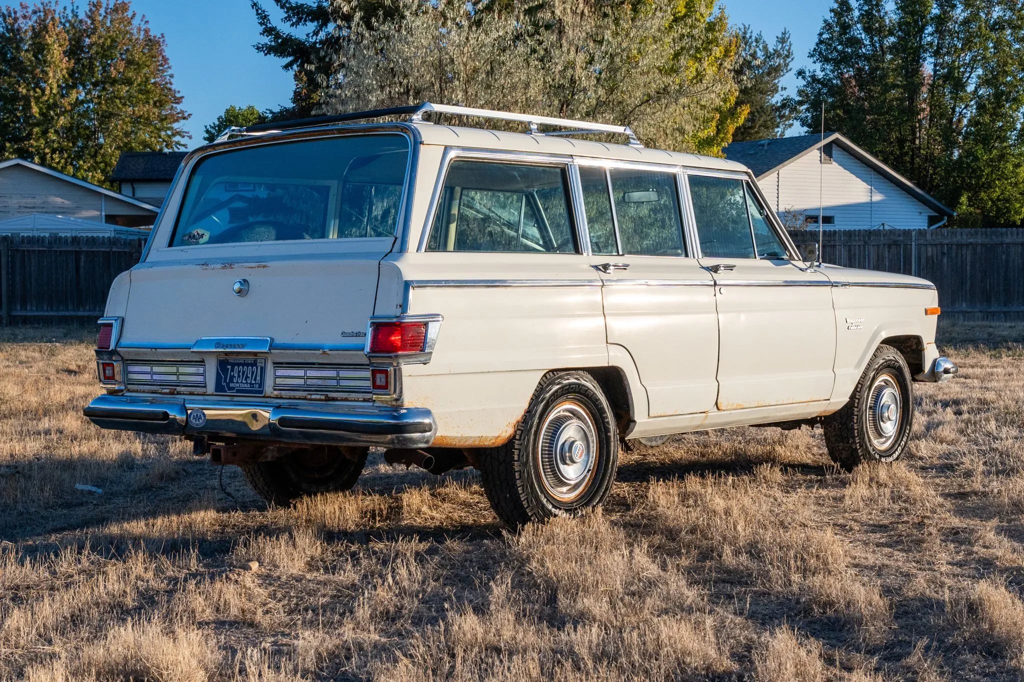 1975 Jeep Wagoneer Custom: A 401-Powered, No-Reserve Example Of America's Greatest Automotive Industrial Design 6 Passenger rear 3q picture of white 1975 Jeep Wagoneer Custom taken from a low angle and facing the sunrise