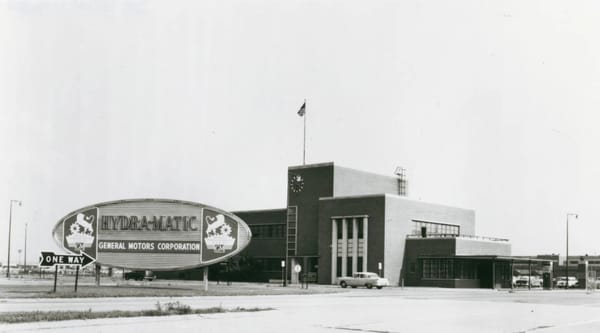 Early Hydra-Matic Users: Many Non-GM Automakers Bought This Pioneering Automatic Transmission 28 B&W photo of Detroit Transmission plant in Ypsilanti, facing the main gate, with a large sign reading "HYDRA-MATIC General Motors Corporation" and the Detroit Transmission logo