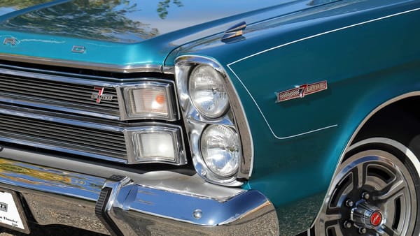 7-Litre badges on the left front fender and grille of a metallic aqua 1966 Ford Galaxie 500