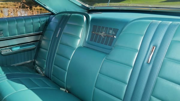 Back seat of a 1966 Ford Galaxie 7-Litre with blue vinyl upholstery