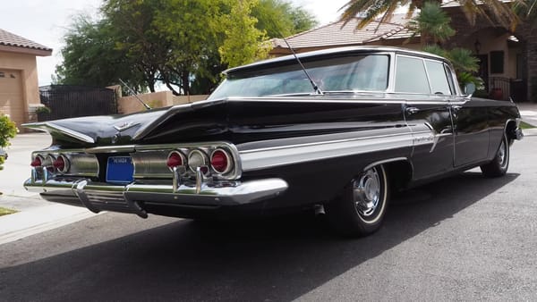 Right rear 3q view of a black 1960 Chevrolet Impala four-door hardtop