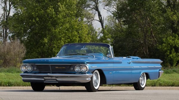 Left front 3q view of a blue 1960 Pontiac Bonneville convertible with the top down