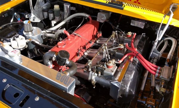 Red motor racing triple Webers
