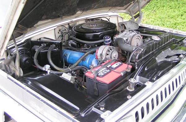 1966–1971 Jeep Super Wagoneer and Wagoneer Custom Special: These Luxury SUVs Were Way Ahead Of Their Time, So Why Didn't They Sell? 10 Jeep Vigilante engine (AMC 327 V-8) under the hood of a Glacier White 1966 Jeep Super Wagoneer