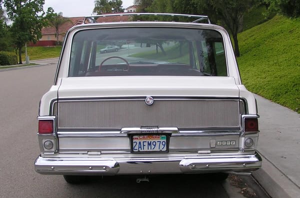 1966–1971 Jeep Super Wagoneer and Wagoneer Custom Special: These Luxury SUVs Were Way Ahead Of Their Time, So Why Didn't They Sell? 13 Rear view of a Glacier White 1966 Jeep Super Wagoneer