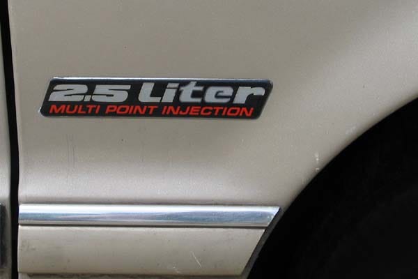 CC Capsule: 1992 Chrysler Spirit—Illegal Alien 2 sidebadge
