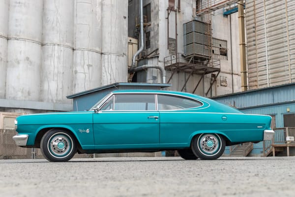 Left side view of a Cortez Aqua 1966 Rambler Marlin fastback in an industrial setting