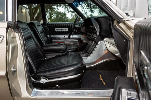 1968 Ford Thunderbird Versus Rivals – How Ford Ranked The T-Bird's Competition 23 Bucket seats and center console of a Pewter Mist 1968 Ford Thunderbird 4-Door Landau with black vinyl upholstery, viewed through the front passenger door