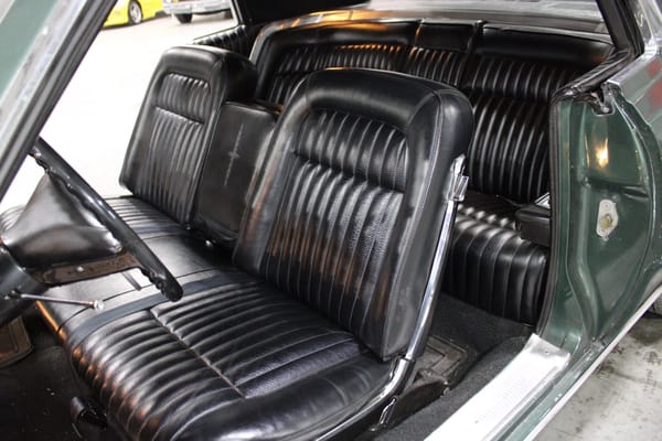 1968 Ford Thunderbird Versus Rivals – How Ford Ranked The T-Bird's Competition 40 Front bench seat of a Highland Green 1968 Ford Thunderbird hardtop with black vinyl upholstery, viewed from over the open driver's door