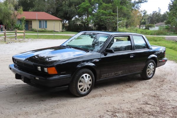 Left front 3q view of a black 1986 Buick Century two-door coupe