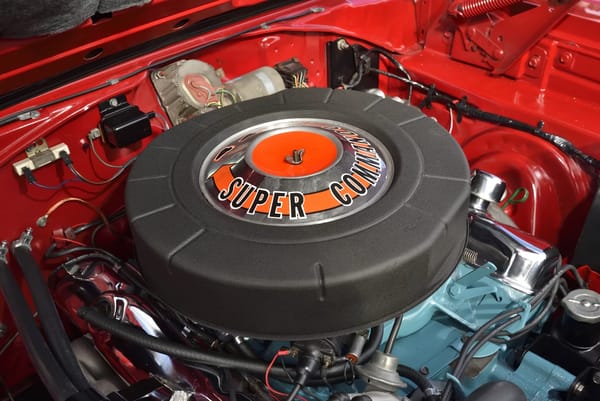Air cleaner of the Super Commando 440 engine under the hood of a Bright Red 1967 Plymouth GTX