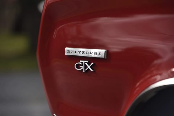Belvedere GTX badges on the left front fender of a Bright Red 1967 Plymouth GTX