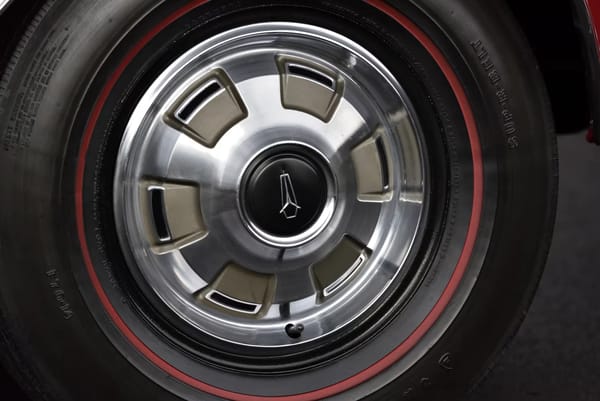 14-inch Deluxe wheel cover and Red Streak tire on a 1967 Plymouth GTX