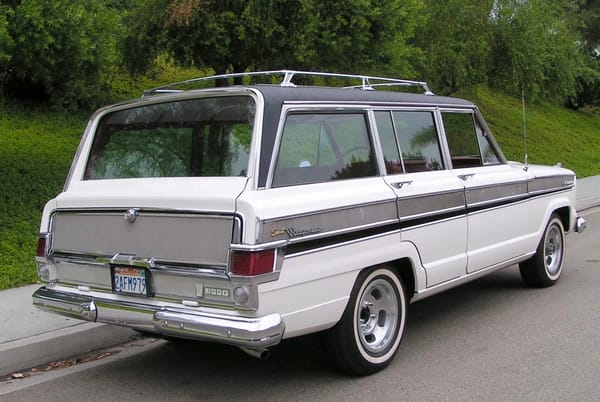 1966–1971 Jeep Super Wagoneer and Wagoneer Custom Special: These Luxury SUVs Were Way Ahead Of Their Time, So Why Didn't They Sell? 15 Right rear 3q view of a Glacier White 1966 Jeep Super Wagoneer with non-stock wheels