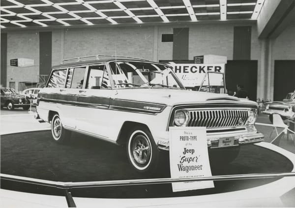 1966–1971 Jeep Super Wagoneer and Wagoneer Custom Special: These Luxury SUVs Were Way Ahead Of Their Time, So Why Didn't They Sell? 3 B&W photo of a 1966 Jeep Super Wagoneer on a display stand at an auto show