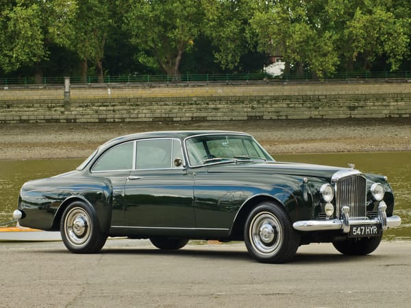 Two Dozen Green Cars And Trucks To Mark The Start of Spring 14 Front 3q view of a Brewster Green 1960 Bentley S2 Continental two-door saloon parked in front of a small green pond or lagoon