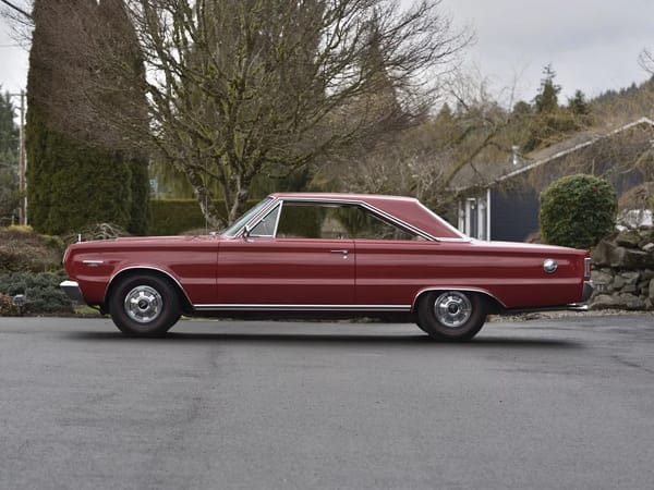 Left side view of a Bright Red 1967 Plymouth GTX hardtop