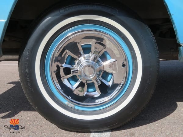 1966–1971 Jeep Super Wagoneer and Wagoneer Custom Special: These Luxury SUVs Were Way Ahead Of Their Time, So Why Didn't They Sell? 6 Mag-style wheel cover and whitewall tire on an Empire Blue 1966 Jeep Super Wagoneer