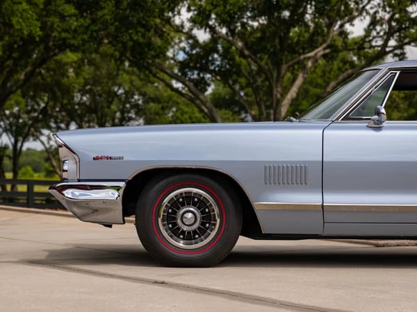 Vintage Car Life Review: 1965 Pontiac Catalina 2+2 421 HO – 2 Plus 2 Does Not Equal GTO 13 Left front fender and 8-lug wheel of a Fontaine Blue 1965 Pontiac Catalina 2+2 hardtop