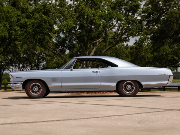 Vintage Car Life Review: 1965 Pontiac Catalina 2+2 421 HO – 2 Plus 2 Does Not Equal GTO 7 Left side view of a Fontaine Blue 1965 Pontiac Catalina 2+2 hardtop with 8-lug wheels and red-stripe tires