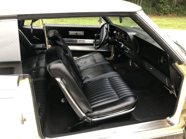 1968 Ford Thunderbird Versus Rivals – How Ford Ranked The T-Bird's Competition 18 Black vinyl Flight-Bench front seat in a yellow 1968 Ford Thunderbird hardtop, viewed through the open passenger door