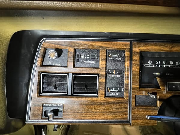 Left side of the instrument panel of a 1974 Imperial LeBaron, showing the secondary gauges and digital chronometer