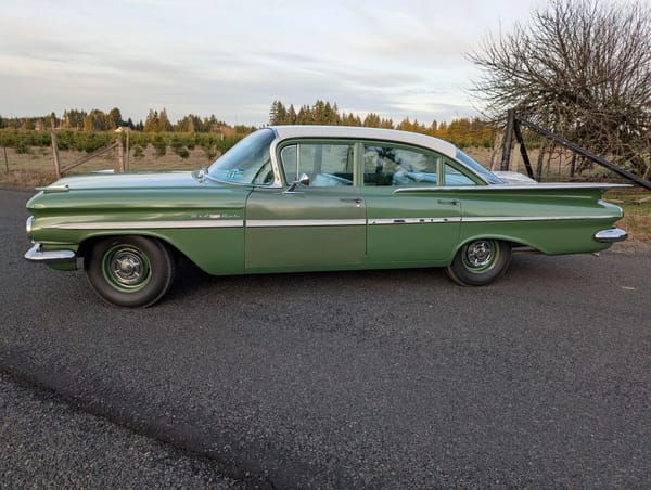 Two Dozen Green Cars And Trucks To Mark The Start of Spring 9 Left side view of a Highland Green 1959 Chevrolet Bel Air four-door sedan with a white roof