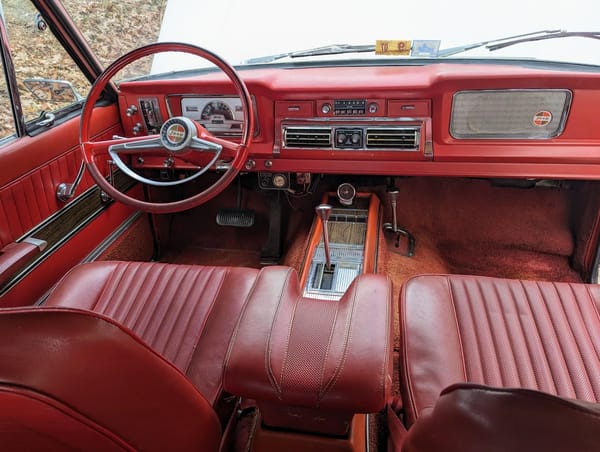 1966–1971 Jeep Super Wagoneer and Wagoneer Custom Special: These Luxury SUVs Were Way Ahead Of Their Time, So Why Didn't They Sell? 11 Dashboard of a 1968 Jeep Super Wagoneer with red upholstery, viewed from the back seat looking forward