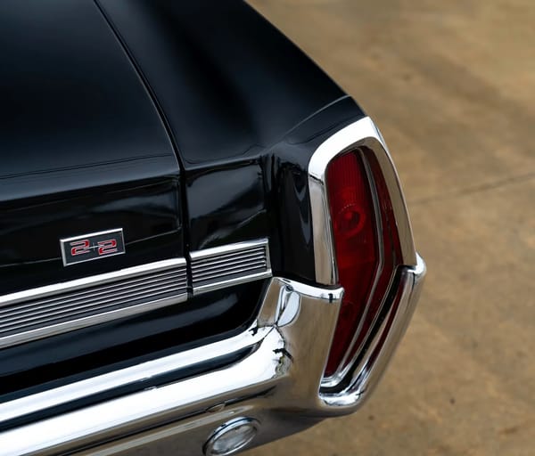 Vintage Car Life Review: 1965 Pontiac Catalina 2+2 421 HO – 2 Plus 2 Does Not Equal GTO 2 2+2 badge and right rear taillight of a black 1964 Pontiac Catalina 2+2