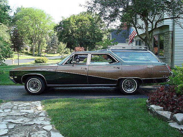side view of a dark green 1969 Buick Sportwagon with woodgrain applique