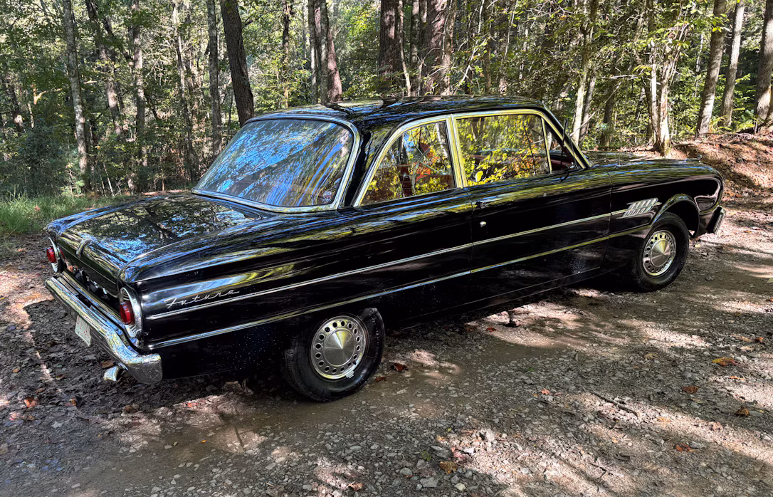 1962 Ford Falcon Futura: A Well-Documented, One-Option Falcon With A 144/Fordomatic 7 Passenger rear 3q view of black 1962 Ford Falcon Futura 2-door sedan in wooded setting